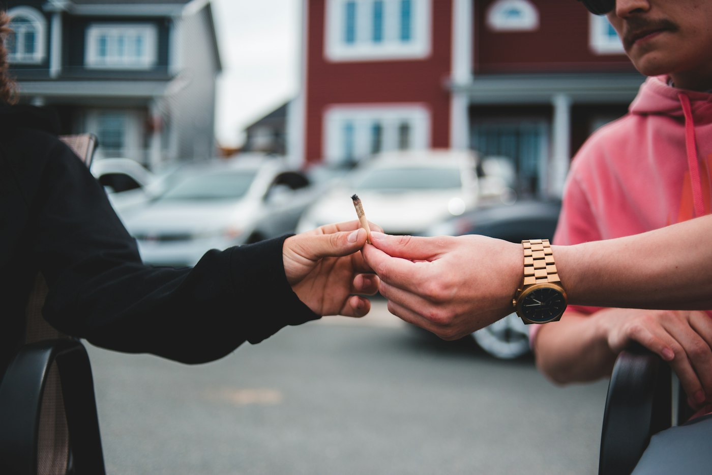 person in black long sleeve shirt holding cigarette stick